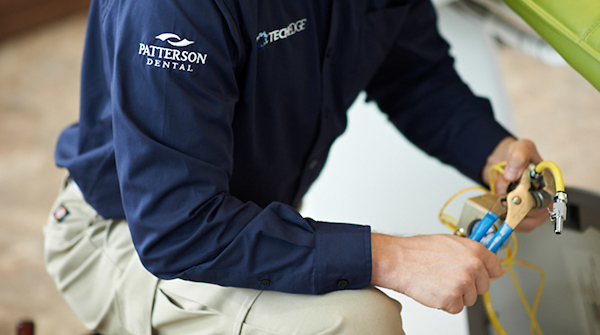 A Patterson technician making a dental equipment repair